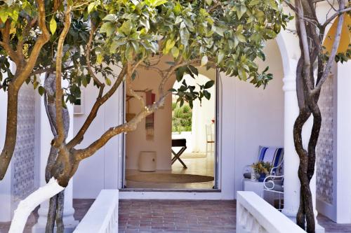 a hallway with trees in front of a door at Octant Vila Monte in Moncarapacho
