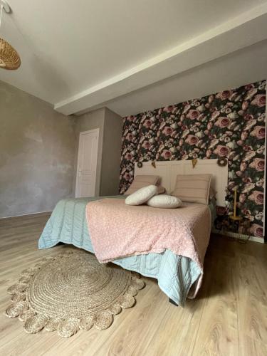 a bedroom with a large bed and a rug at La Bohème in Condom