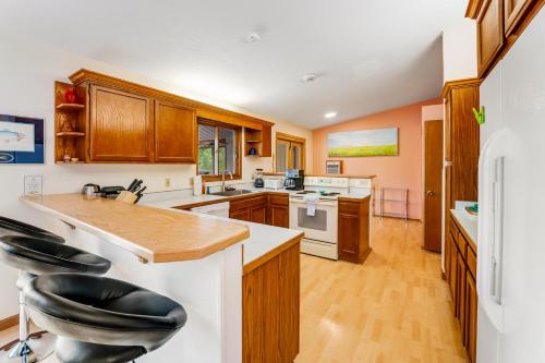 a kitchen with wooden cabinets and a counter top at Lazy K on Peaceful Bay - Full Property in Lakeside