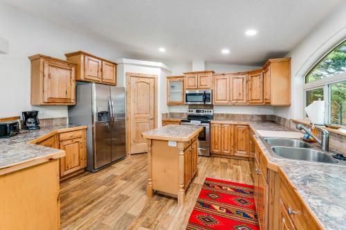 a kitchen with wooden cabinets and stainless steel appliances at Lazy K on Peaceful Bay - Full Property in Lakeside