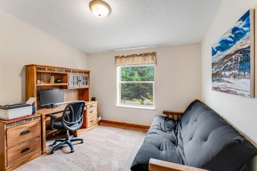 a living room with a couch and a desk with a computer at Lazy K on Peaceful Bay - Full Property in Lakeside