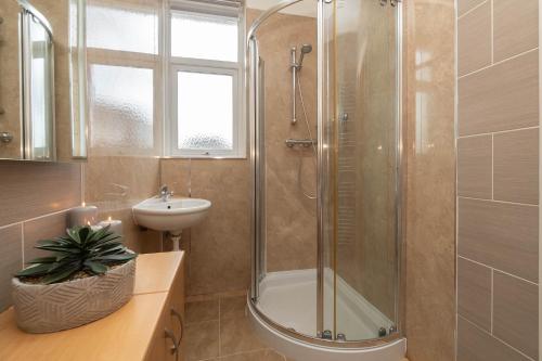 a bathroom with a shower and a sink at Dwellcome Home Ltd 3 Double Bedroom Semi with Garden and Drive in Aberdeen