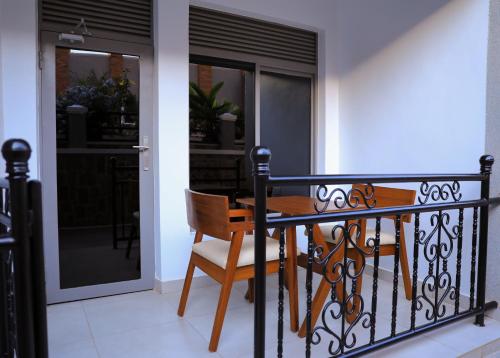 a dining room table and chair on a balcony at Velvet Suites in Kigali