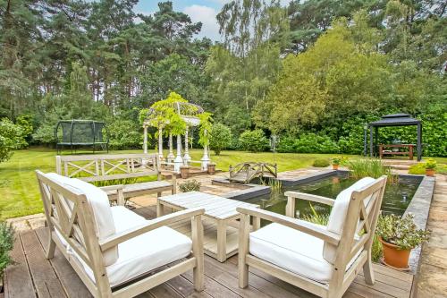 a patio with a table and chairs and a gazebo at Scotsdale - exclusive family home in Ringwood