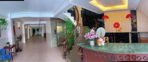 a hallway of a hospital with a counter and stairs at HƯƠNG LAN HOTEL in Ho Chi Minh City