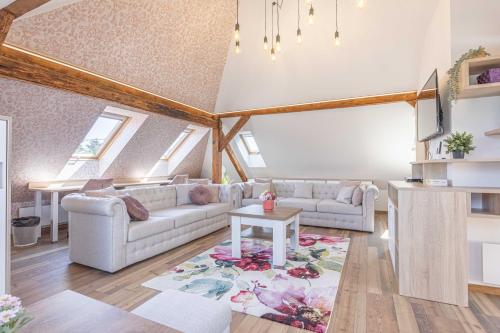 a living room with two couches and a table at Casa PERLA in Dunajská Streda