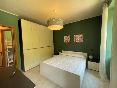 a bedroom with a bed and a green wall at Il Fiume by Holiday World in Castagnelo