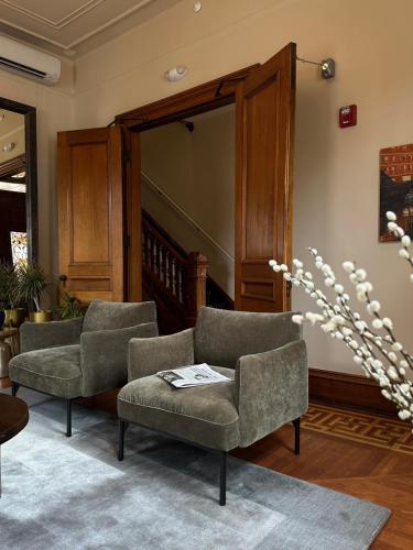 a living room with two chairs and a couch at The Francis Hotel in Portland