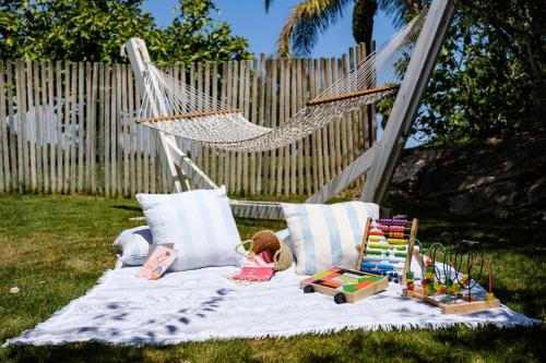 a swing bed with a doll and toys on it at Octant Vila Monte in Moncarapacho