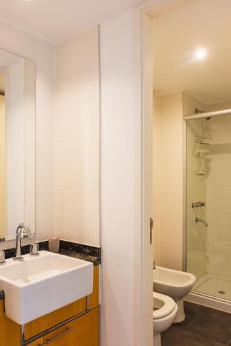 a white bathroom with a sink and a toilet at Depto - Lago los Molinos in Potrero de Garay