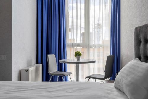 Кровать или кровати в номере barasport city apartments