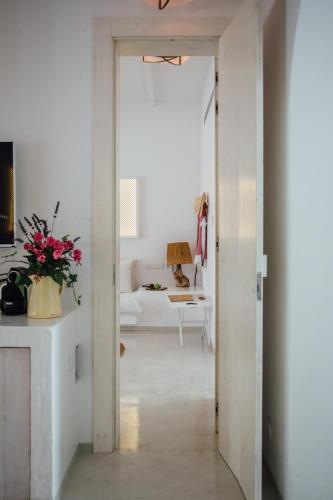a hallway with a white room with a white couch at Octant Vila Monte in Moncarapacho