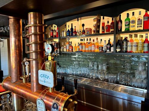 a bar with a lot of bottles and glasses at Lohmann's Kapeller Hof in Langenfeld