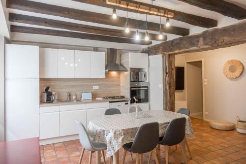a kitchen with a table and chairs in a room at Coeur de Blois Maison T3 in Blois