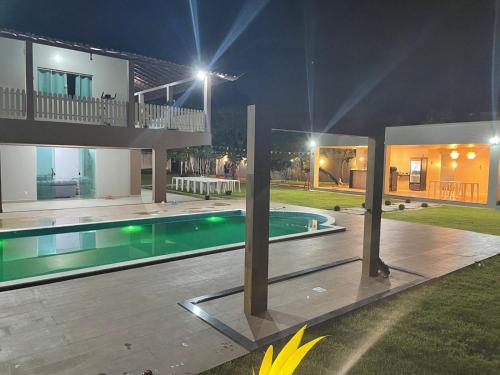 a house with a swimming pool at night at Solar Calixto in Belém