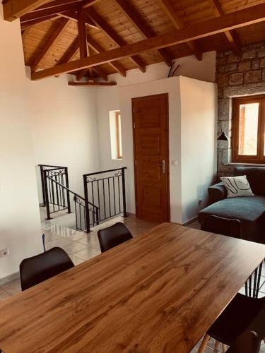 a dining room with a wooden table and chairs at Villa Pantazi in Riglia