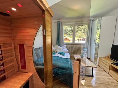 a mirror in a room with a bed in it at Pöstlingbergoase in Linz