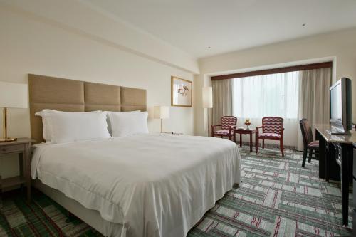 Postel nebo postele na pokoji v ubytování The Howard Plaza Hotel Kaohsiung