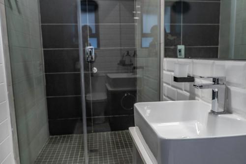 a bathroom with a shower and a sink at Rand Corner Crib in Pretoria