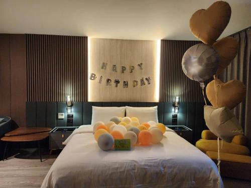 a bed with a bunch of balloons on it at Hualien Pink Corner Hotel in Hualien City
