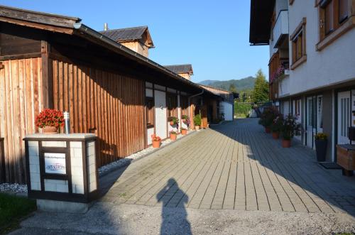 a brick walkway in front of a building at Pension zum Schreiner in Hermagor