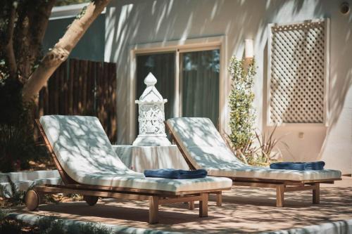 two chairs sitting on a patio in front of a house at Octant Vila Monte in Moncarapacho