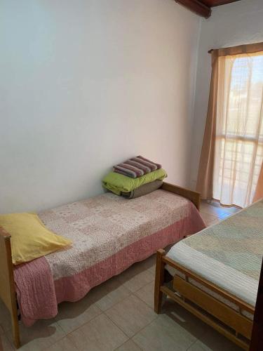 a room with two beds and a window at Departamento termal in Federación