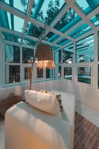 a living room with a white couch and a chandelier at Octant Vila Monte in Moncarapacho