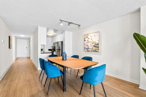 a dining room with a wooden table and blue chairs at Sunset Haven 3-Bedrooms 2-Baths in Los Angeles