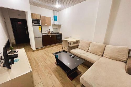 a living room with a couch and a table at South La Apartments in Accra