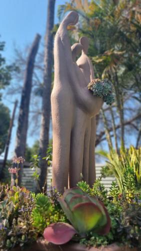 a statue of two people hugging in a garden at Zoete Rust Boutique Hotel in Lephalale