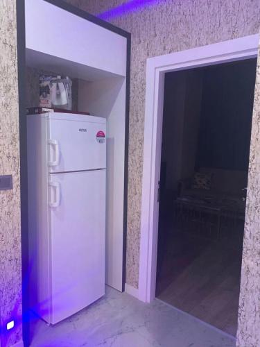 a white refrigerator in a room with an open door at Antalya centre in Antalya