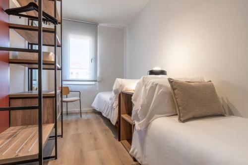 a bedroom with a bunk bed and a ladder at Arrivo Apartments in Barcelona