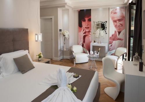 a white bedroom with a white bed and a living room at Terrazza Marco Antonio Luxury Suite in Rome
