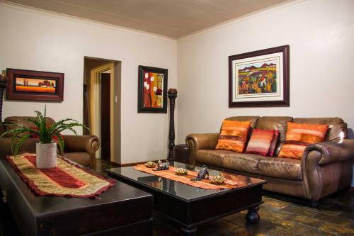 a living room with a couch and a coffee table at Zoete Rust Boutique Hotel in Lephalale