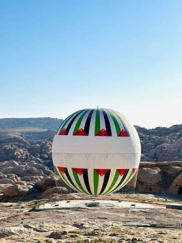 a hot air balloon sitting on top of a mountain at Nabateans Home Hotel in Wadi Musa