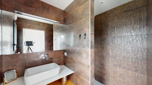 une salle de bain avec un lavabo et un miroir dans l'établissement VILLA OCEAN ZEN, à Combrit