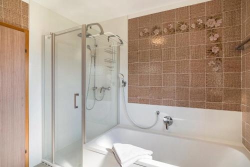 a bathroom with a shower and a bath tub at Ferienwohnung Burgblick in Sinsheim
