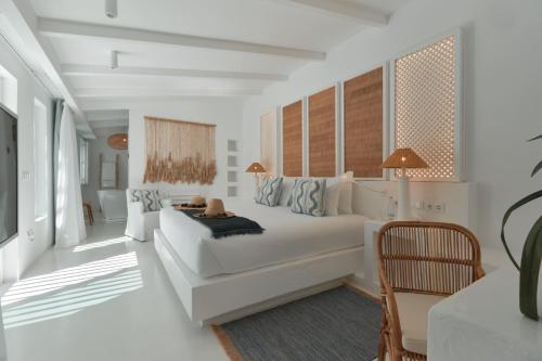 a white living room with a white couch and a table at Octant Vila Monte in Moncarapacho