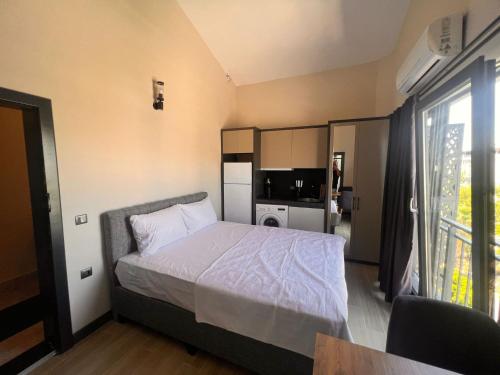 a small bedroom with a bed and a kitchen at Hayal Fener in Antalya