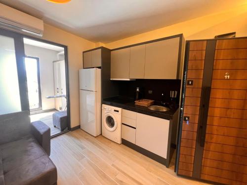 a kitchen with a refrigerator and a washer and dryer at Hayal Fener in Antalya