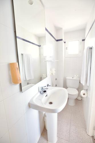 a white bathroom with a sink and a toilet at JS Horitzó in Can Picafort
