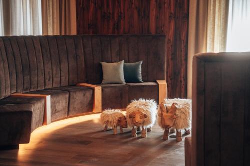two fake animals in a room with a couch at Dilly - Das Nationalpark Resort in Windischgarsten