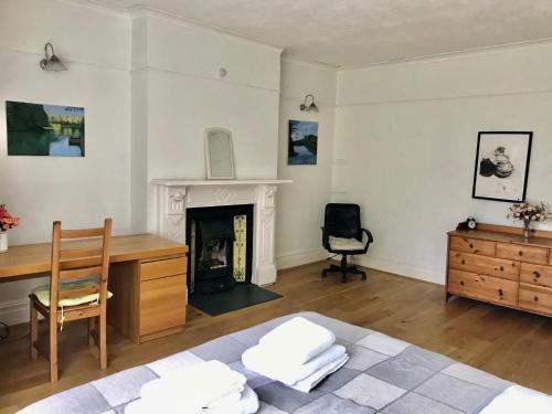 un soggiorno con scrivania e sedia di Spacious 3 Bed Room Flat in South West London a Londra