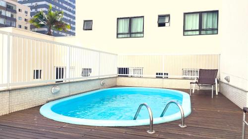 a swimming pool on the roof of a building at Hotel Italia in Balneário Camboriú
