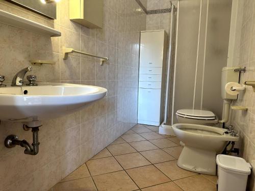 a bathroom with a sink and a toilet at Delta Blu Residence Village in Lido di Pomposa