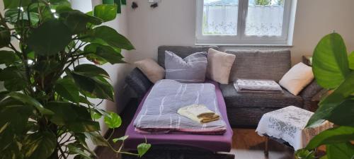 a living room with a couch with a blanket at Ferienwohnung Bergidyll in Schwarzenberg (Erzgebirge)