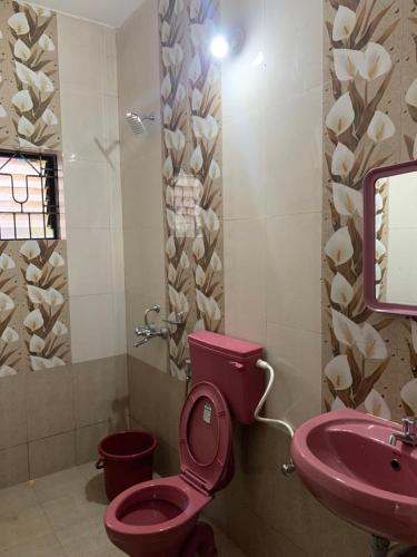 a bathroom with a pink toilet and a sink at Casa De Calangute Inn in Calangute