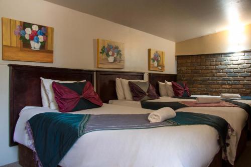 two beds in a hotel room with two bedsvisor at Zoete Rust Boutique Hotel in Lephalale