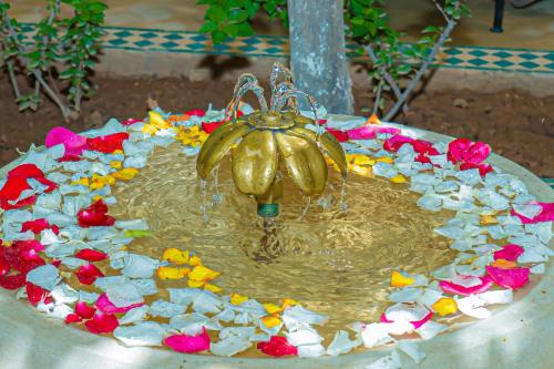 a fountain with a bunch of flowers in it at Riad Dar Zaouia in Marrakech